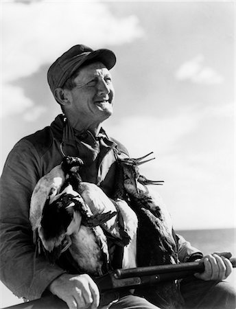 1940s SENIOR MAN HOLDING SHOTGUN AND DEAD DUCKS DUCK SHOOTING Stock Photo - Rights-Managed, Code: 846-02792459