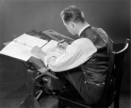 drafting table - 1940s 1950s REAR BACK VIEW MAN SEATED AT DRAFTING TABLE WORKING DRAWINGS WORK OCCUPATION BLUEPRINTS DRAFTSMAN WORKER Stock Photo - Rights-Managed, Code: 846-02792450