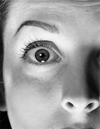 1940s 1950s 1960s CLOSE-UP OF WOMAN'S NOSE AND EYE OPENED VERY WIDE WITH ARCHED BROW LOOKING AT CAMERA Stock Photo - Rights-Managed, Code: 846-02792469