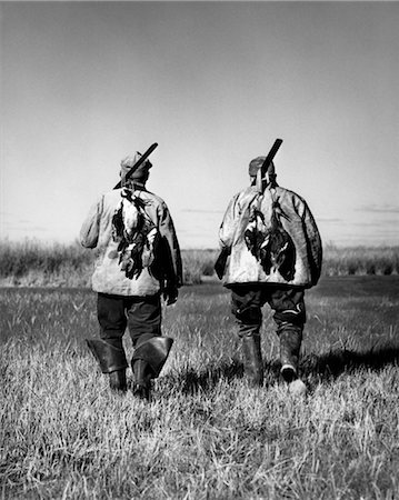 1940s TWO MEN BACK VIEW WALKING FIELD DUCK HUNTING SPORT Stock Photo - Rights-Managed, Code: 846-02792460