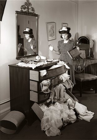 1940s 1950s SHOCKED WOMAN MESSY RANSACKED BUREAU CHEST OF DRAWERS IN BEDROOM Stock Photo - Rights-Managed, Code: 846-02792506