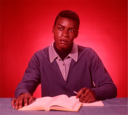 1960s AFRICAN AMERICAN STUDENT STUDYING TEXTBOOKS Stock Photo - Rights-Managed, Code: 846-02792578