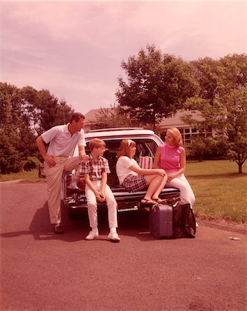 father son trip - 1960s FAMILY SITTING ON BACK STATION WAGON LOADED WITH LUGGAGE FOR VACATION Stock Photo - Rights-Managed, Code: 846-02792579