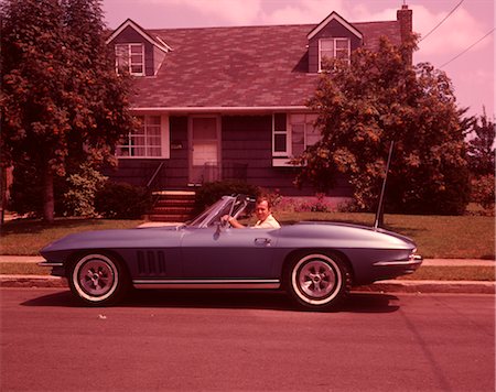 1960s MAN IN CORVETTE CONVERTIBLE IN FRONT OF HOUSE Stock Photo - Rights-Managed, Code: 846-02792605