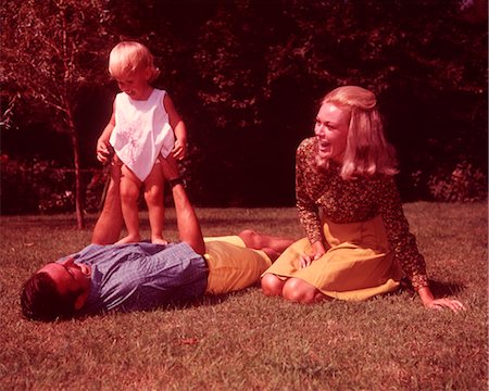 1960s FAMILY ON GRASS FATHER HOLDING UP TODDLER Stock Photo - Rights-Managed, Code: 846-02792606