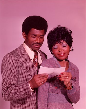1960s AFRICAN AMERICAN COUPLE LOOKING AT CHECK Stock Photo - Rights-Managed, Code: 846-02792649