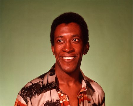 1970s PORTRAIT AFRICAN AMERICAN MAN GREEN BACKGROUND Stock Photo - Rights-Managed, Code: 846-02792679