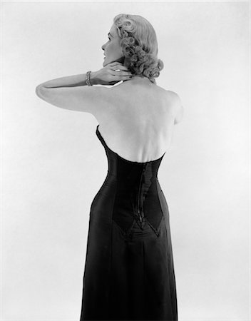 retro scene - 1950s BACK VIEW WOMAN BLACK STRAPLESS GOWN DRESS ARMS UP TO NECK Stock Photo - Rights-Managed, Code: 846-02792854