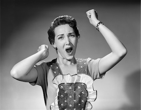 simsearch:846-02796223,k - 1950s WOMAN IN APRON RUFFLED EDGE FISTS UP IN AIR YELLING SCREAMING ANGRY HOUSEWIFE EXPRESSION COMPLAIN NAG DARN Stock Photo - Rights-Managed, Code: 846-02792981
