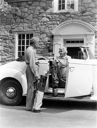 1940ER JAHRE ALTER EHEMALIGER PAAR LADEN GOLFCLUBS IN WEIßE CABRIO AUTO VORNE STEINHAUS Stockbilder - Lizenzpflichtiges, Bildnummer: 846-02793081