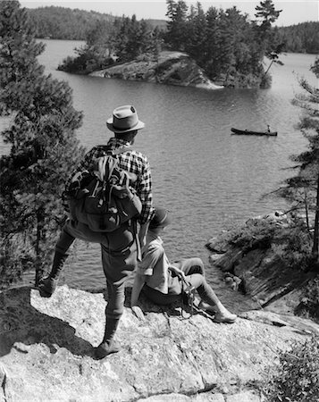 forest boat - 1930s COUPLE HIKING TOGETHER LOOKING AT CANOE LAKE OF THE WOODS ONTARIO CANADA Stock Photo - Rights-Managed, Code: 846-02793254