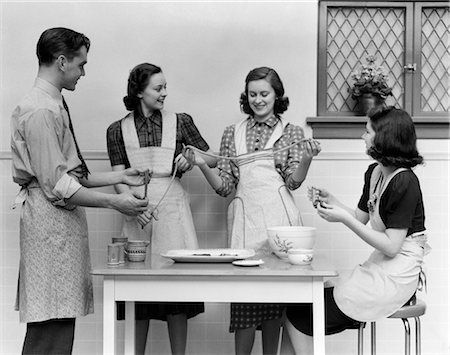 friends cooking together - 1930s 1940s WOMEN 1 MAN APRONS IN KITCHEN PULLING TAFFY Stock Photo - Rights-Managed, Code: 846-02793283