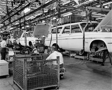 simsearch:846-02793389,k - 1960s CHRYSLER ASSEMBLY LINE WITH CAR BODIES ELEVATED FOR EMPLOYEES TO WORK UNDER THEM Stock Photo - Rights-Managed, Code: 846-02793398