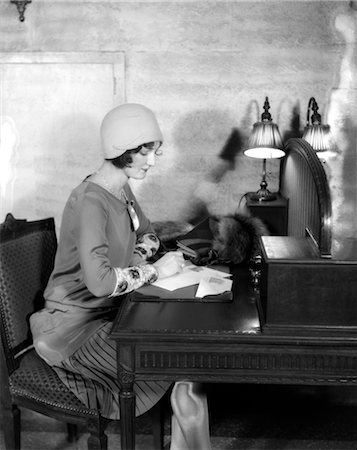 people writing desk lamp - 1920s WOMAN SITTING AT DESK WRITING LETTER BY LAMP FASHION CLOCHE HAT HOTEL LOBBY Stock Photo - Rights-Managed, Code: 846-02793420