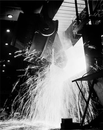 1970s LARGE CONTAINER OF MOLTEN MATERIAL WITH SPARKS FLYING AT STEEL PLANT Stock Photo - Rights-Managed, Code: 846-02793421