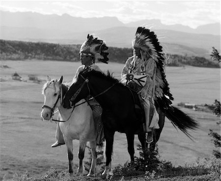 1930s PAIR OF SIOUX INDIANS WEARING HEADDRESSES ON HORSEBACK Stock Photo - Rights-Managed, Code: 846-02793447