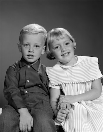 1960s SMILING BLOND BOY & GIRL SITTING TOGETHER HOLDING HANDS WITH HEADS PRESSED TOGETHER Stock Photo - Rights-Managed, Code: 846-02793492