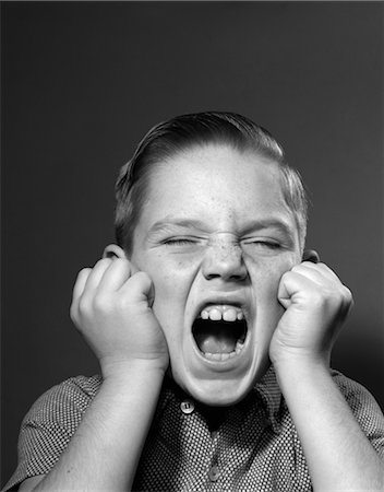 1950s PORTRAIT SCREAMING BOY MOUTH WIDE OPEN ANGRY CLINCHED FISTS Stock Photo - Rights-Managed, Code: 846-02793591