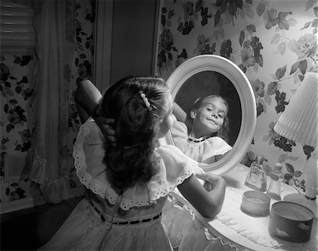 simsearch:846-08512702,k - 1950s LITTLE GIRL POSING REFLECTED IN MIRROR AT VANITY TABLE Stock Photo - Rights-Managed, Code: 846-02793673