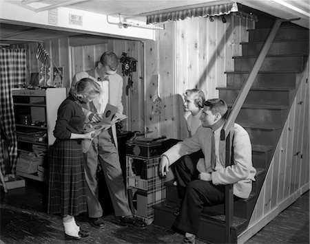 1950s GROUP TEENS BOYS GIRLS PLAYING RECORDS ON PHONOGRAPH KNOTTY PINE REC ROOM Stock Photo - Rights-Managed, Code: 846-02793746
