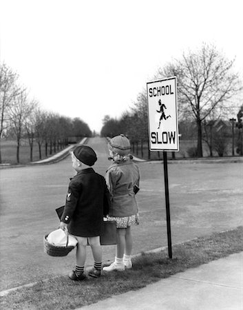 slow - 1930s 1940s BOY GIRL WAITING TO CROSS STREET BY SCHOOL SLOW SIGN Foto de stock - Con derechos protegidos, Código: 846-02793776