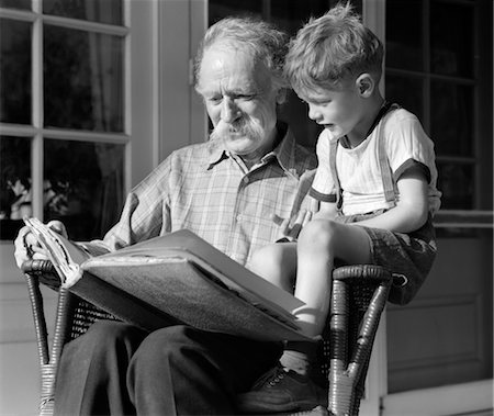 simsearch:846-02793841,k - 1940s GRANDFATHER ON PORCH READING TO GRANDSON Stock Photo - Rights-Managed, Code: 846-02793772