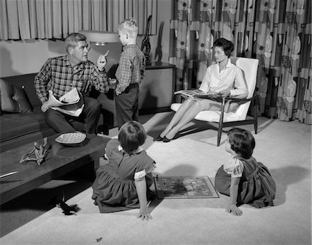 fingering mom photo - 1960s FAMILY OF FOUR IN LIVING ROOM BOY SON IS BEING DISCIPLINED BY DAD SHAKING FINGER Stock Photo - Rights-Managed, Code: 846-02793813