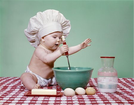 simsearch:846-03163340,k - BABY GIRL IN CHEF HAT USING SPOON AND MIXING BOWL STUDIO EGGS BUTTER MILK Stock Photo - Rights-Managed, Code: 846-02793976