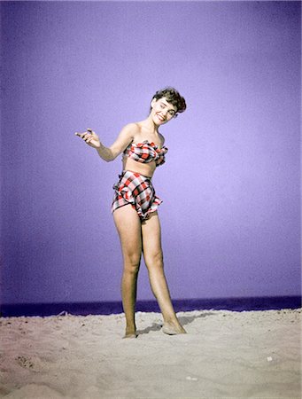 1940s 1950s FULL LENGTH WOMAN WEARING PLAID TWO PIECE BATHING SUIT SWIMWEAR STANDING ON SAND FASHION Stock Photo - Rights-Managed, Code: 846-02793978