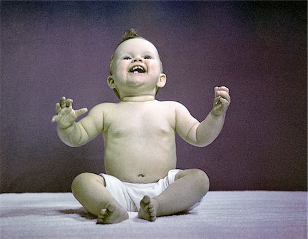 1940s 1950s FULL BODY SITTING BABY LAUGHING HANDS ARMS RAISED Stock Photo - Rights-Managed, Code: 846-02793972