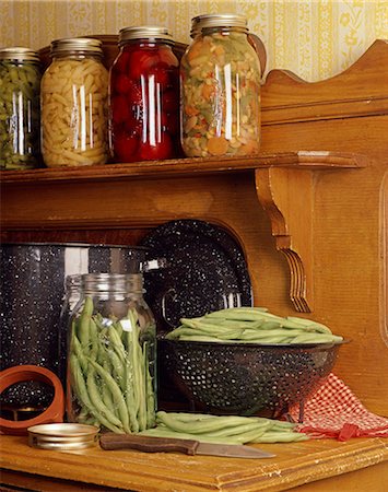 VINTAGE WOODEN KITCHEN COUNTER WITH GREEN BEANS IN COLANDER AND JARS OF CANNED VEGETABLES Foto de stock - Con derechos protegidos, Código: 846-03164237