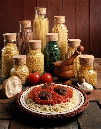 food 1980s - 1980s DISH OF SPAGHETTI AND MEATBALLS WITH JARS OF PASTA NOODLES Stock Photo - Rights-Managed, Code: 846-03164269
