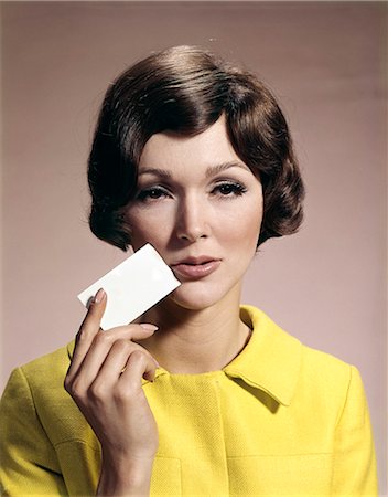 face card - 1960s WOMAN HOLDING BLANK BUSINESS CARD TO FACE Stock Photo - Rights-Managed, Code: 846-03164526