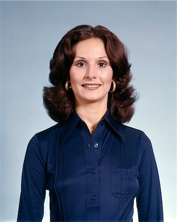 1970s PORTRAIT OF SMILING BRUNETTE WOMAN WEARING GOLD HOOP EARRINGS AND BLUE SHIRT Stock Photo - Rights-Managed, Code: 846-03164558
