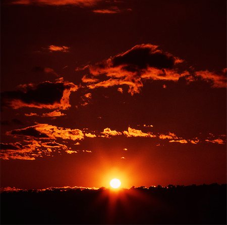 simsearch:846-03164921,k - LANDSCAPE OF YELLOW BALL OF SUN SETTING ON THE HORIZON WITH RED ORANGE SKY Stock Photo - Rights-Managed, Code: 846-03164927