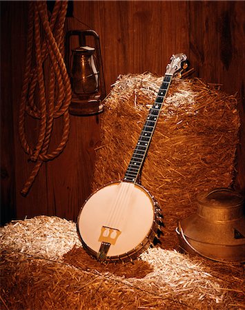 COUNTRY MUSIC STILL LIFE OF BANJO ON BALES OF HAY IN BARN Stock Photo - Rights-Managed, Code: 846-03165011