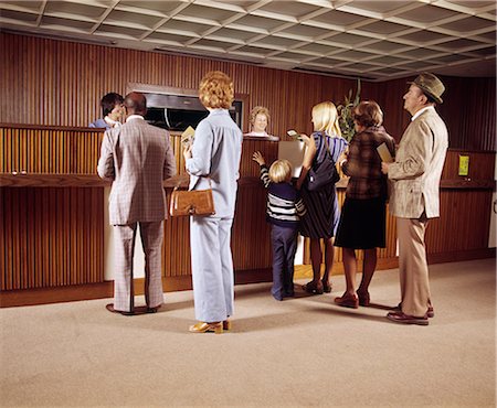 simsearch:846-02796076,k - 1970s LINE OF MEN WOMEN CHILDREN WAITING FOR BANK TELLER Stock Photo - Rights-Managed, Code: 846-03165151