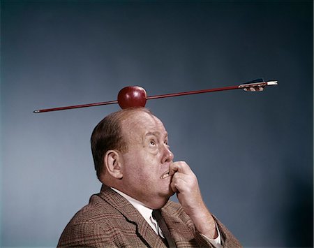 precision and accuracy william tell - 1960s ANXIOUS BUSINESS MAN BITING FINGER WITH NAILS ARROW SHOT THROUGH APPLE ON OF HIS TOP HEAD Stock Photo - Rights-Managed, Code: 846-03165234