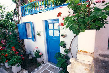 MYKONOS, GREECE WHITE HOUSE WITH BLUE TRIM AND GERANIUMS Foto de stock - Con derechos protegidos, Código: 846-03165353