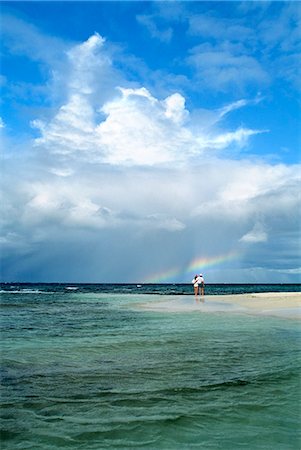 seashells on the beach - MAN AND WOMAN STANDING OFF IN THE DISTANCE, ADMIRING A RAINBOW MOPION ISLAND, GRENADINES, WEST INDIES Stock Photo - Rights-Managed, Code: 846-03165751