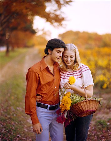 romantic road - 1970s AFFECTIONATE YOUNG COUPLE WITH BASKET OF FLOWERS ON COUNTRY ROAD AUTUMN ROMANTIC MAN WOMAN Stock Photo - Rights-Managed, Code: 846-03165783