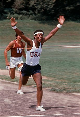 runner finish line - 1970s 2 RUNNERS AFRICAN-AMERICAN MAN BREAKING TAPE AT FINISH LINE Stock Photo - Rights-Managed, Code: 846-03165811