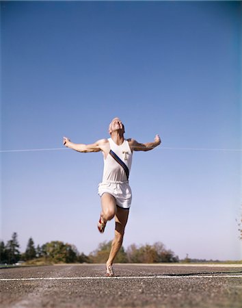 retro fitness - 1960s MAN WINNING RACE RUNNING THROUGH TAPE AT FINISH LINE Stock Photo - Rights-Managed, Code: 846-03165868