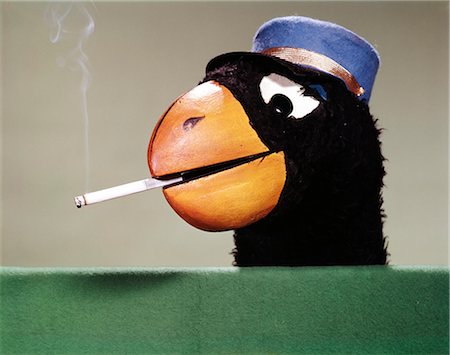 simsearch:846-02797696,k - 1970s PARROT HEAD COSTUME HAND PUPPET WITH SMOKING CIGARETTE IN ITS BEAK Stock Photo - Rights-Managed, Code: 846-03165870