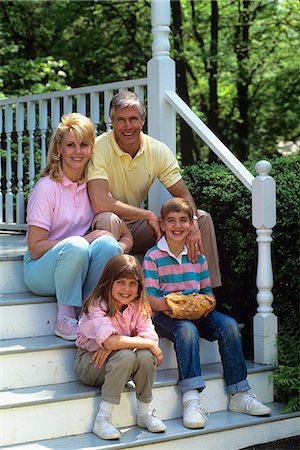 retro suburban house - 1990s PARENTS WITH TWO CHILDREN SITTING ON PORCH STEPS Stock Photo - Rights-Managed, Code: 846-03165893