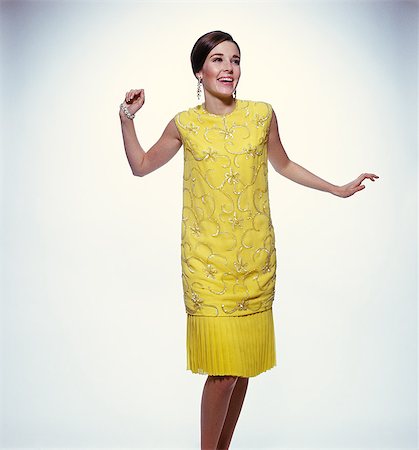 1960s SMILING BRUNETTE WOMAN MODELING YELLOW SEQUINED COCKTAIL DRESS CLOTHES Stock Photo - Rights-Managed, Code: 846-03165982