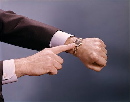 pointing at watch - 1960s MAN HANDS POINTING WRIST WATCH TIME Stock Photo - Rights-Managed, Code: 846-03166017