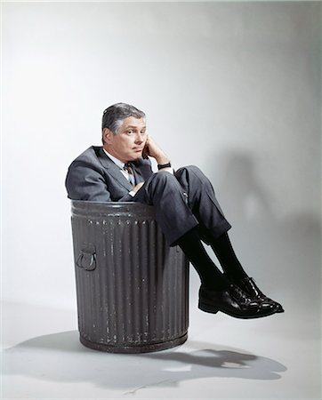 1960s SAD MAN IN BUSINESS SUIT SITTING IN TRASH GARBAGE CAN Stock Photo - Rights-Managed, Code: 846-03166010