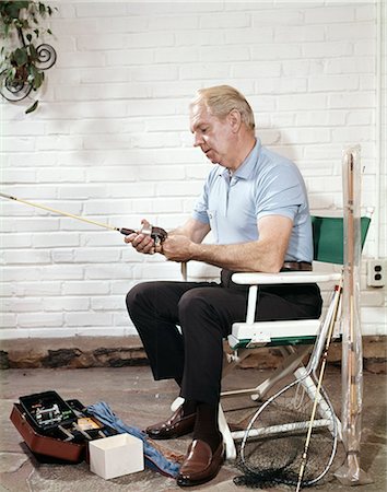simsearch:846-02794968,k - 1960s SENIOR MAN SITTING DIRECTORS CHAIR HOLDING FISHING ANGLING ROD REEL Stock Photo - Rights-Managed, Code: 846-03166023