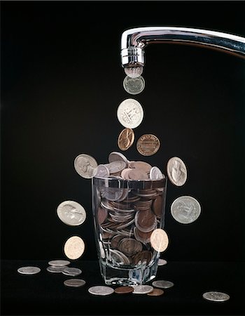 1960s COINS FALLING OUT OF WATER FAUCET INTO GLASS Stock Photo - Rights-Managed, Code: 846-03166067